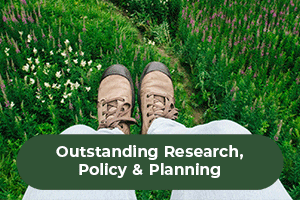 Walking boots in a green field